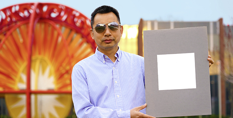 Xiulin Ruan, a Purdue University professor of mechanical engineering, holds up his lab’s sample of the whitest paint on record. (Purdue University/Jared Pike)